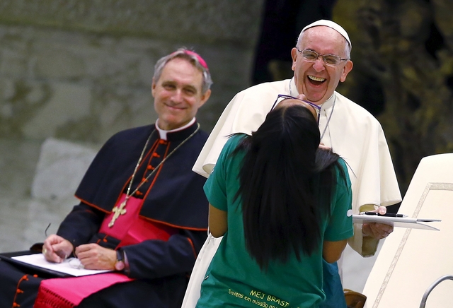 Pope Francis jokes during a special audience with members of "Eucharist Youth Movement" in Paul VI hall at the Vatican, August 7, 2015. REUTERS/Tony Gentile TPX IMAGES OF THE DAY