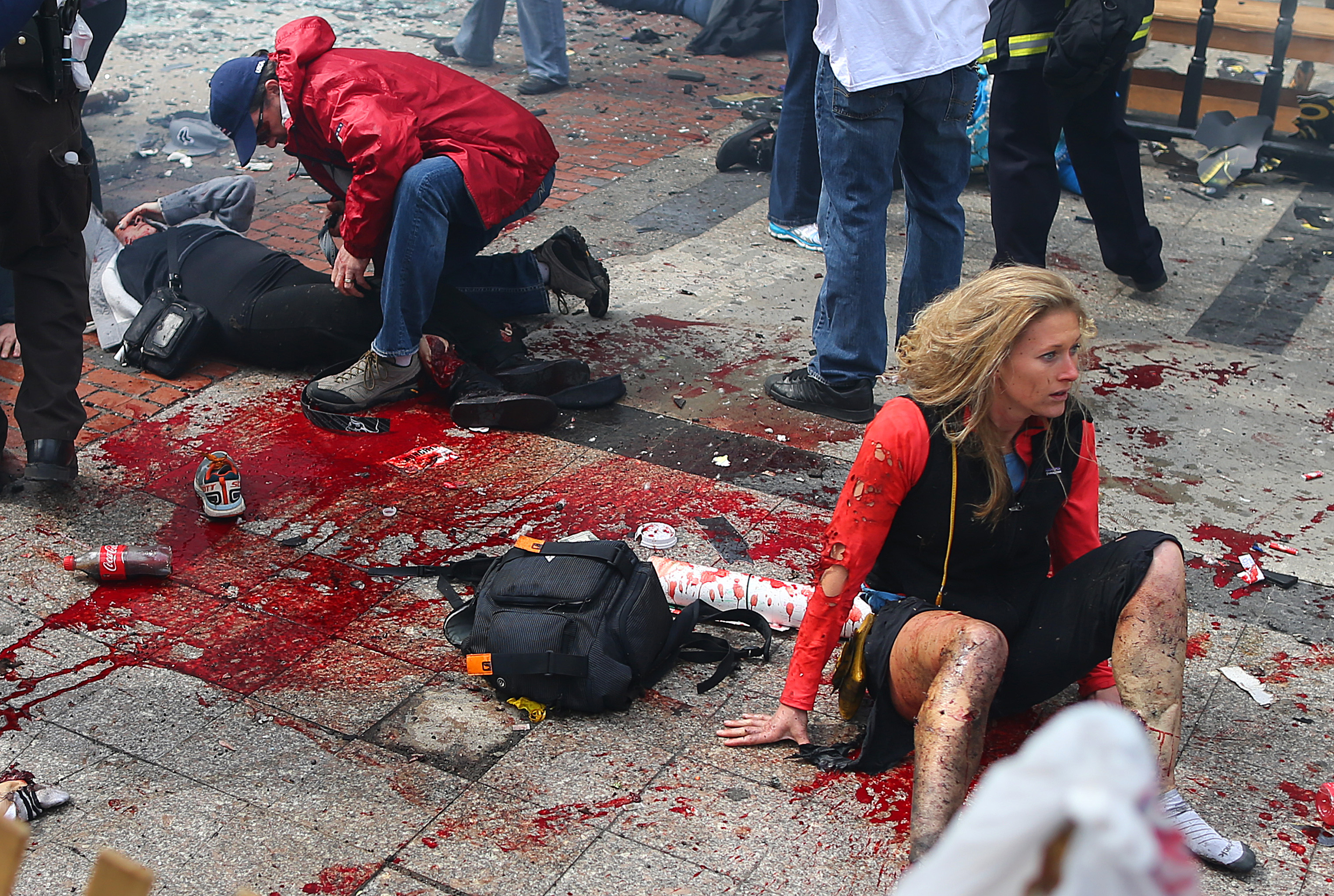 BOSTON - APRIL 15: (EDITOR'S NOTE: THIS IMAGE CONTAINS GRAPHIC CONTENT) Victims are in shock and being treated at the scene of the first explosion that went off near the finish line of the Boston Marathon. (Photo by John Tlumacki/The Boston Globe via Getty Images)